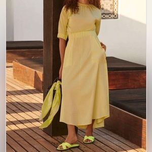 Green dress with button details on the back.